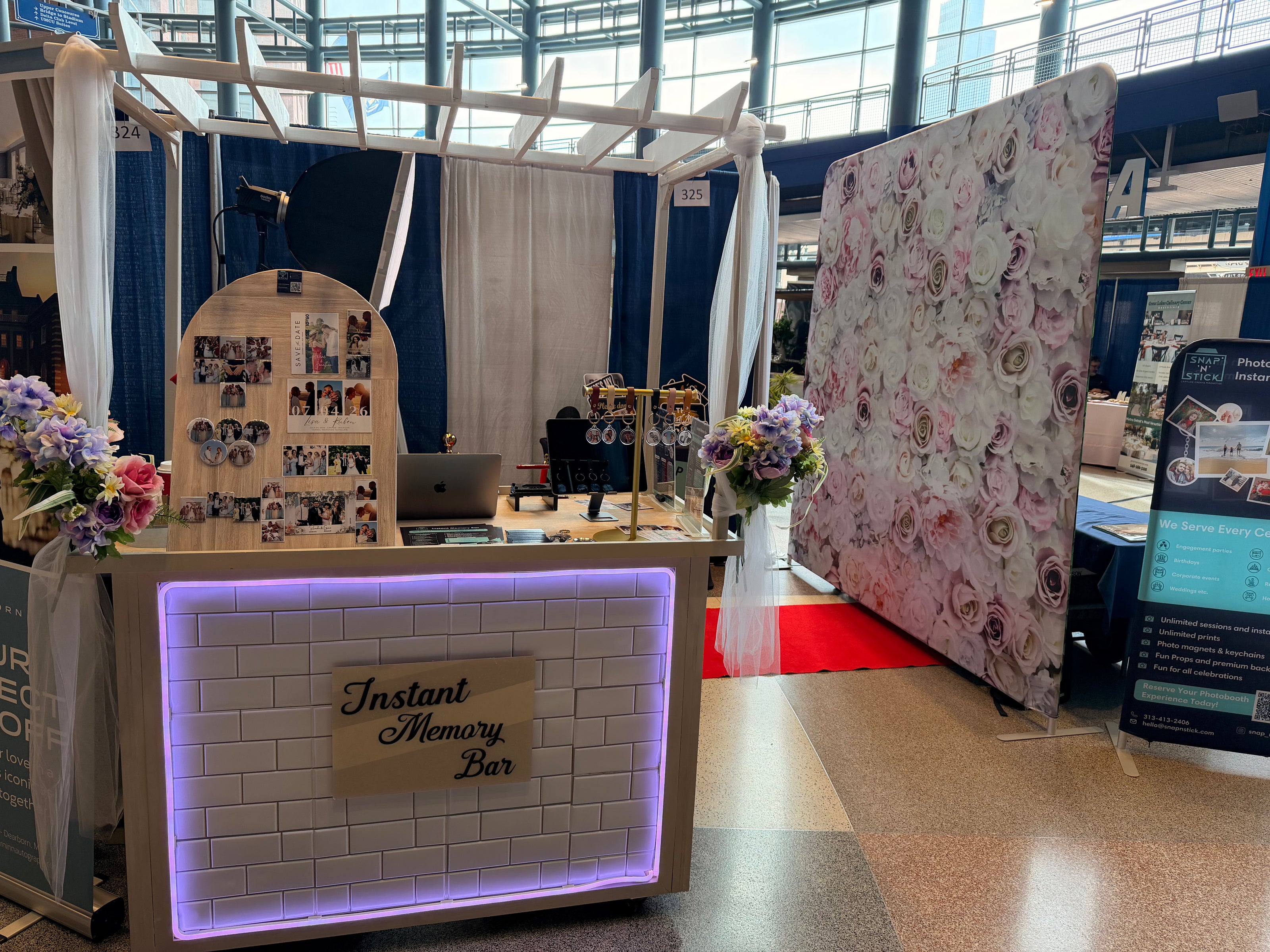 Instant Memory Bar setup with photo display and floral decorations in a indoor setting