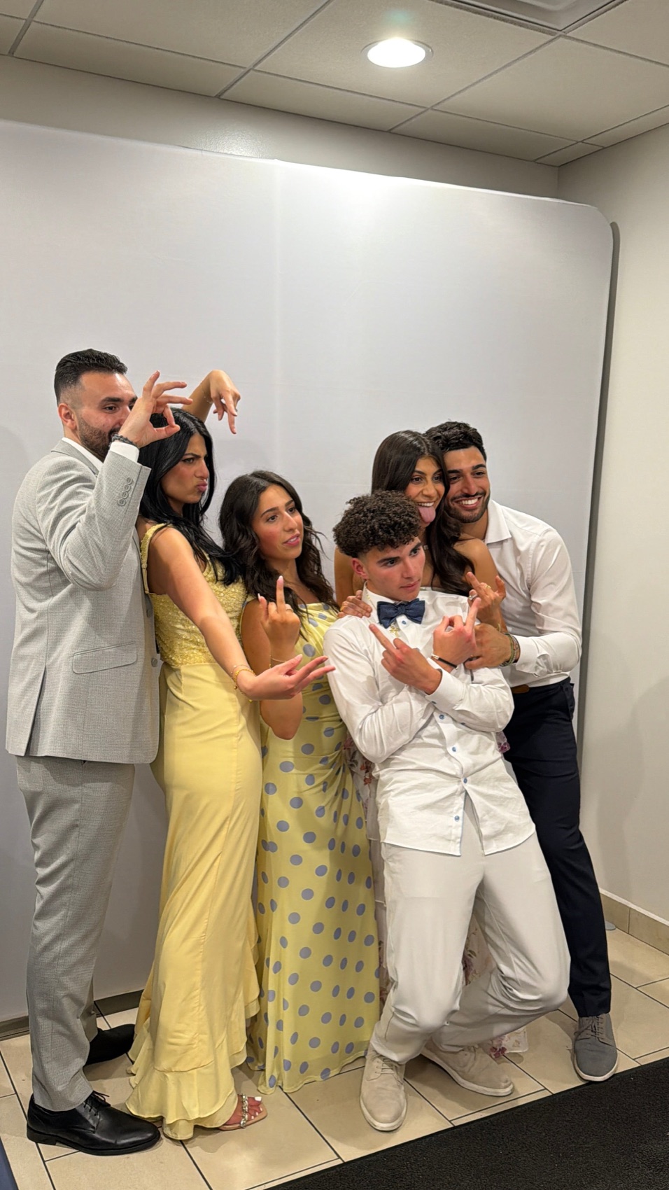 Friends laughing at a Snap'N'Stick photo booth